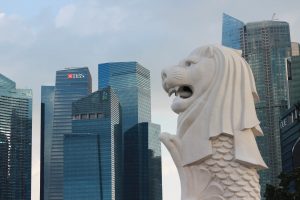 singapore merlion in focused with high rise offices in the background