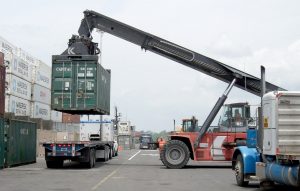 vehicle loading a cargo container onto a truck