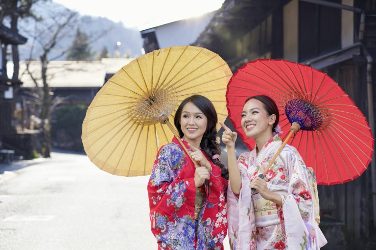 Two Beautiful girl wearing traditional japanese kimono in popular in Old village at Nagano Prefecture, Japan.