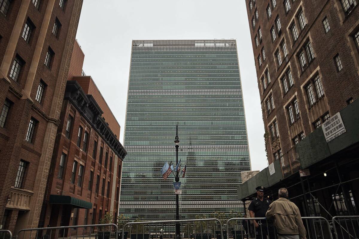 A man talks to a police office outside the UN building, Monday, Sept. 18, 2017 in New York. Pre ...