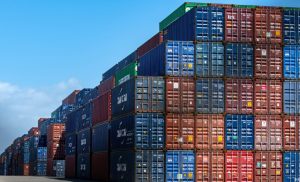 Shipping containers stacked on top of each other at a port.