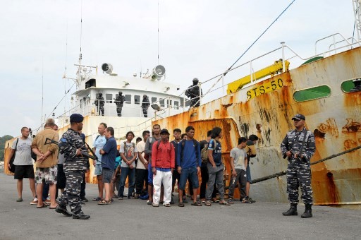 Soldiers from the Indonesian Military (TNI) guard the crew of an alleged &ldquo;slave ship&rdquo; at the naval port of Sabang, Aceh, on April 7, 2018.