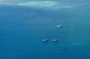 Several vessels identified by the Philippine Coast Guard as maritime militia vessels belonging to China sail near Thitu Island in the South China Sea on March 9, 2023.