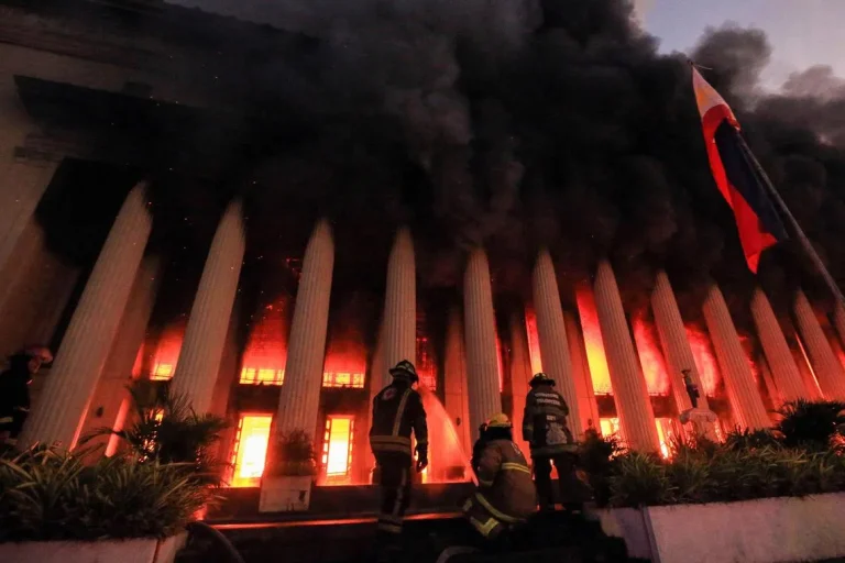 Firefighters douse a fire at the Post Office building in Manila on May 22, 2023. 